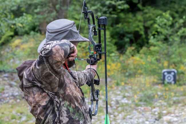 Hunter Shooting A Compound Bow At An Archery Target Hunter Shooting A Compound Bow At An Archery Target